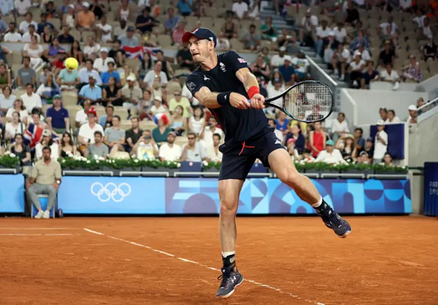 Andy Murray of Team Great Britain plays a backhand with partner