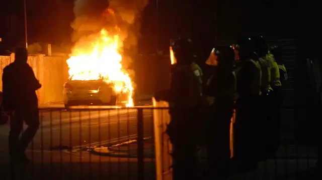 A police car burns during disorder in Hartlepool