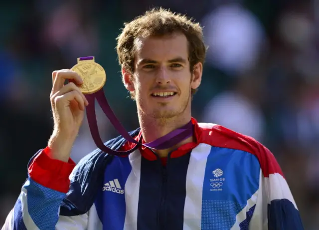 Andy Murray poses with his 2012 Olympic medal