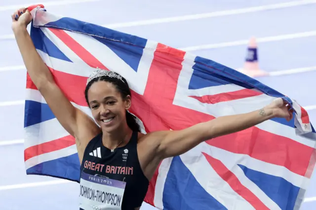 Katarina Johnson-Thompson holding the Union Jack flag up