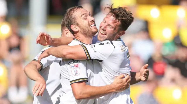 Bromley players celebrate scoring a goal