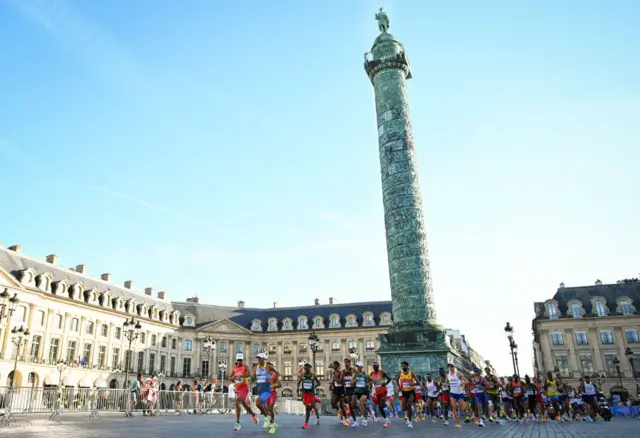 The marathon runners going past the Vendome Column