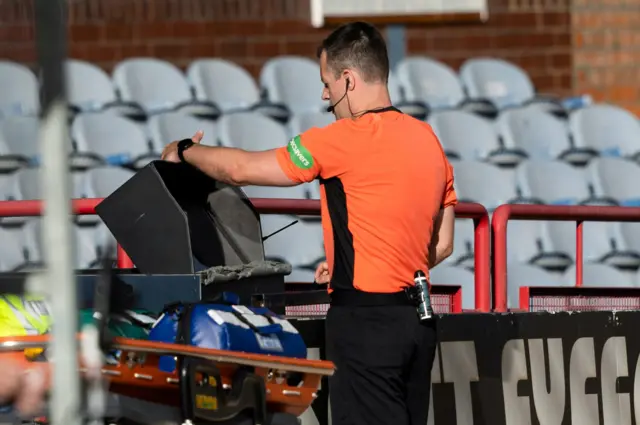 Referee Don Robertson at the VAR monitor