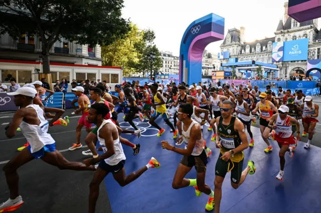 The runners crossing the start line at the men's marathon