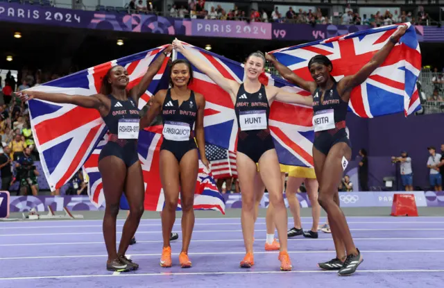 Great Britain's 4x100m relay team with Union Jack flags