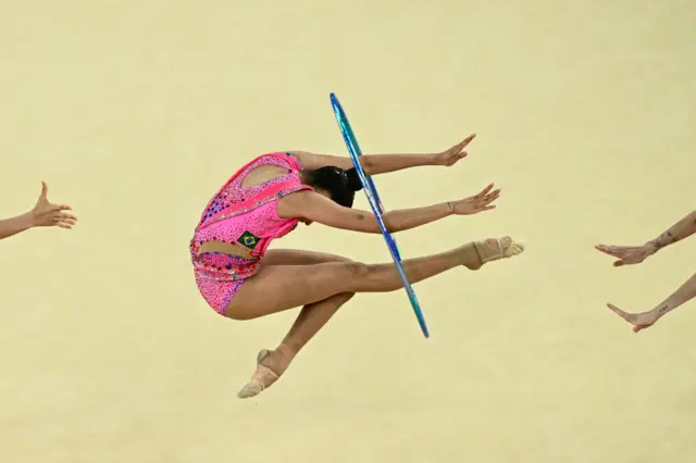 Brazil's gymnasts perform with the hoop as they compete in the rhytmic gymnastics' group all-around qualification during the Paris 2024 Olympic Games at the Porte de la Chapelle Arena