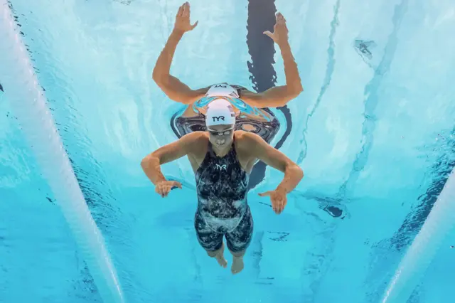 An underwater view shows US' Katie Grimes competing in the heats of women's 400m individual medley swimming event during the Paris 2024 Olympic Games at the Paris La Defense Arena in Nanterre