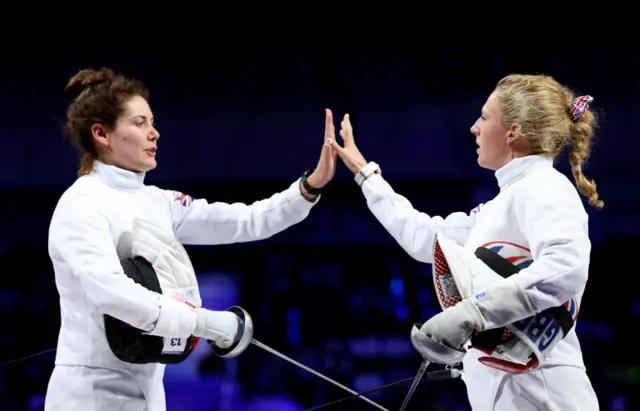 Kate French and Karenza Bryson high five each other at the Paris Olympics