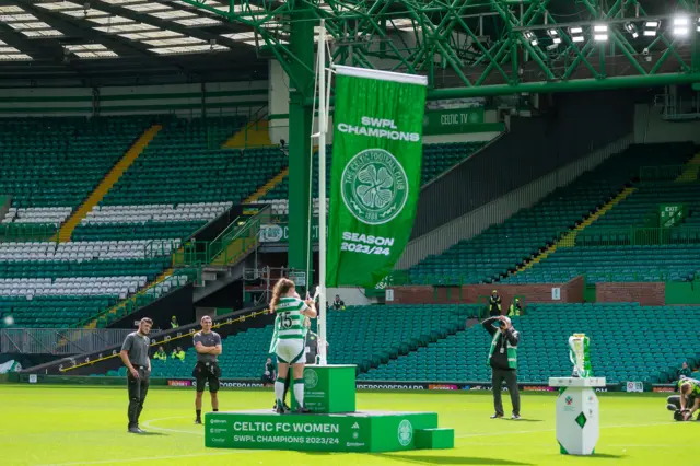 Kelly Clark raising the league winners flag at Parkhead