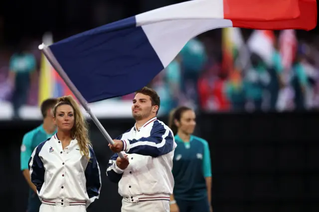 lagbearers Antoine Dupont and Pauline Ferrand Prevot of Team France wave their national flag during the Closing Ceremony of the Olympic Games Paris