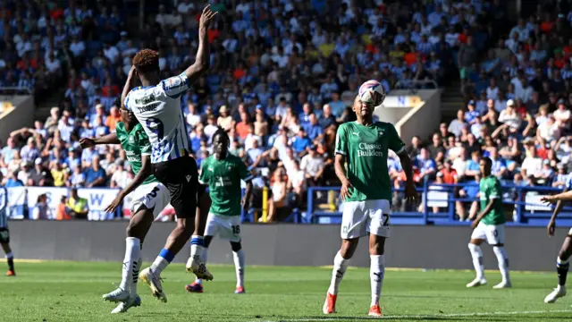 Brendon Galloway heads the ball into his own net