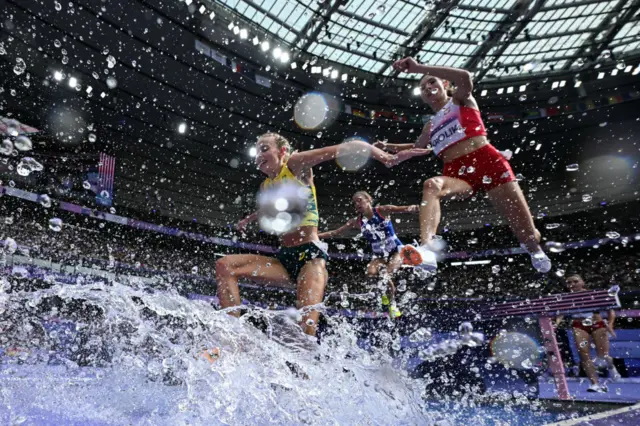 Athletes compete in the women's 3000m steeplechase heat of the athletics event at the Paris 2024 Olympic Games at Stade de France in Saint-Denis