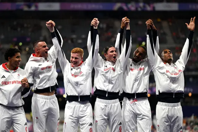 Bronze medallists Britain's Samuel Reardon, Britain's Toby Harries, Britain's Charles Dobson, Britain's Lewis Davey, Britain's Matthew Hudson-Smith, Britain's Alex Haydock-Wilson celebrate on the podium after competing in the men's 4X400m relay final of the athletics event during the Paris 2024 Olympic Games at Stade de France in Saint-Denis