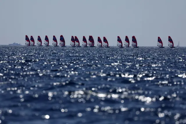 Windsurfers take the start of Race 1 of the men's IQFoil windsurfing event during the Paris 2024 Olympic Games sailing competition at the Roucas-Blanc Marina in Marseille