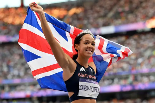 Katarina Johnson-Thompson holding the Union Jack flag up