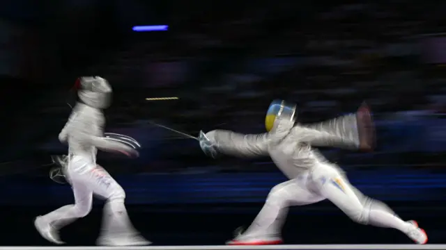 South Korea's Jeon Eun-hye (L) competes against Ukraine's Alina Komashchuk in the women's sabre team gold medal bout between South Korea and Ukraine during the Paris 2024 Olympic Games at the Grand Palais in Paris