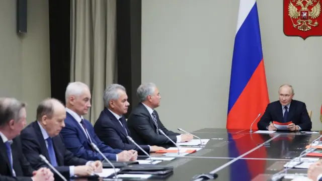 Russian President Vladimir Putin (R) chairs a meeting with members of the Russian Security Council at the Novo-Ogaryovo state residence, outside Moscow, Russia,