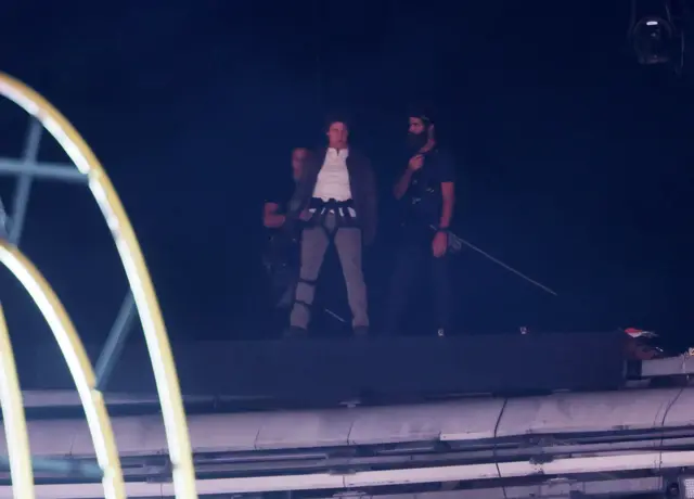 Tom Cruise prepares to perform a stunt during the Closing Ceremony of the Paris 2024 Olympic Games at the Stade de France Stadium in Paris