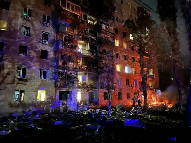 Blown out windows and damaged balconies on several floors of a building in the city of Kursk