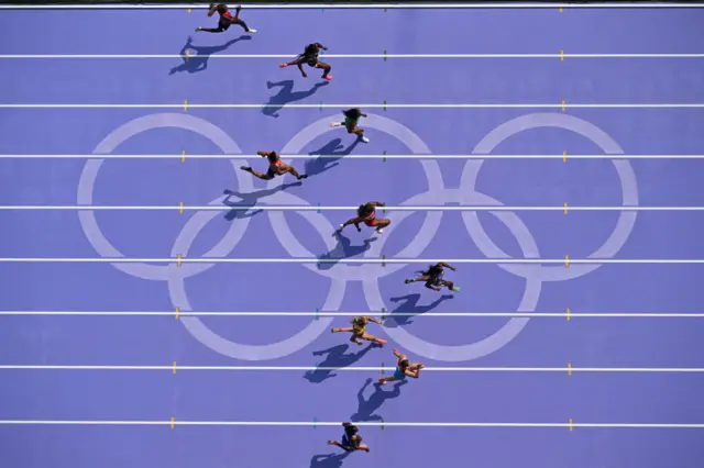 An overview shows US' Sha'Carri Richardson leading as athletes compete in the women's 100m heat of the athletics event at the Paris 2024 Olympic Games at Stade de France in Saint-Denis