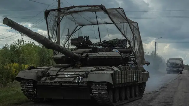 Two tanks on a dirt track