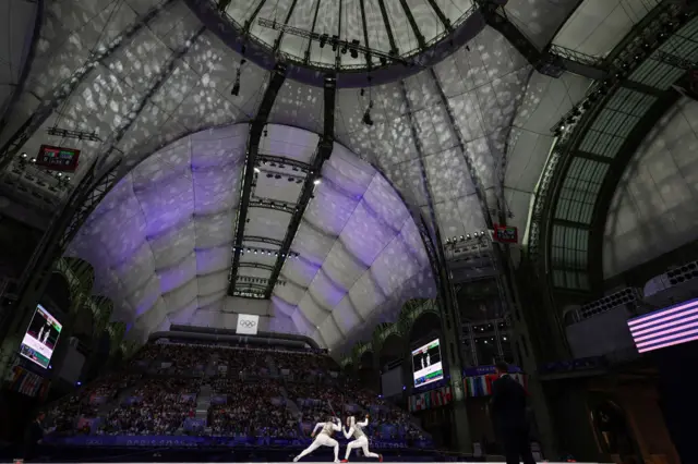 Italy's Martina Favaretto (L) and US' Lauren Scruggs (R) compete in the women's foil team gold medal bout between Italy and USA