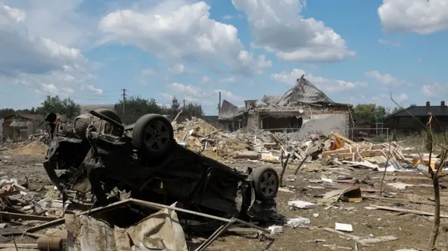 An overturned car among debris