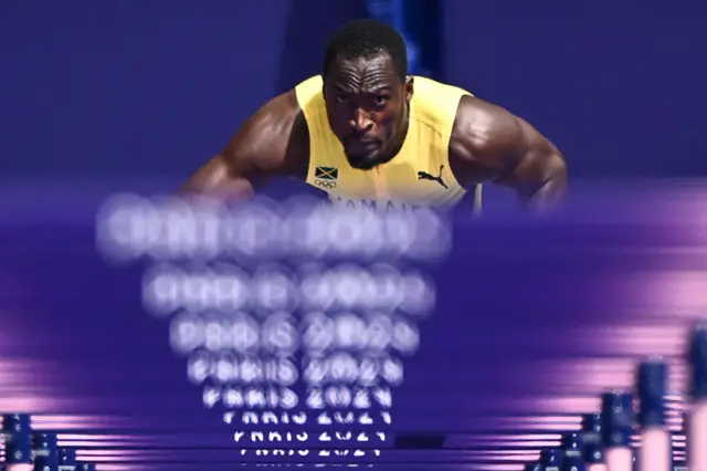 Jamaica's Hansle Parchment prepares to take the start in the men's 110m hurdles heat of the athletics event at the Paris 2024 Olympic Games at Stade de France in Saint-Denis