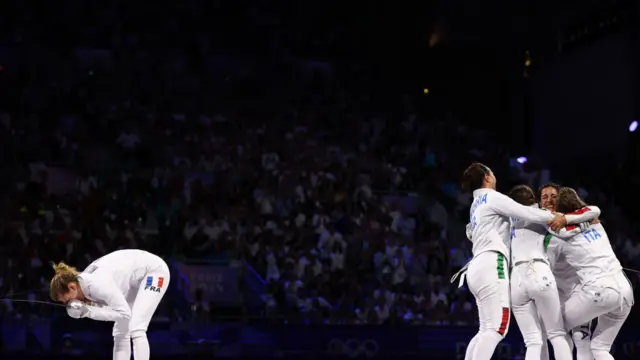 France's Auriane Mallo-Breton (L) reacts after losing against Italy's team (R) in the women's epee team gold medal bout between France and Italy during the Paris 2024 Olympic Games at the Grand Palais in Paris