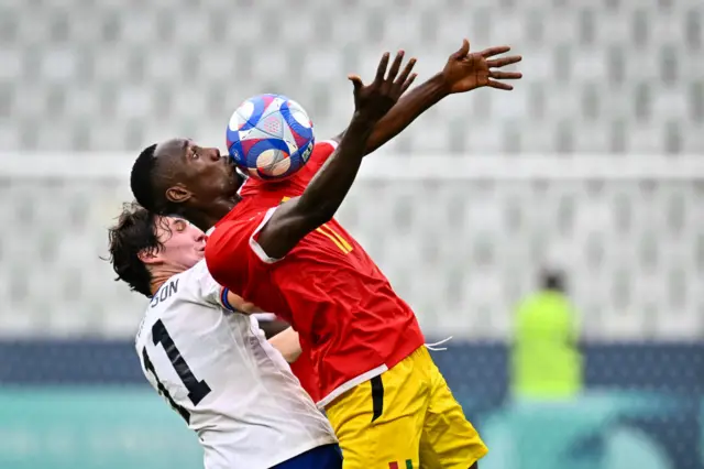 Guinean forward Ousmane Camara #11 (R) fights for the ball with U11 (L) in the men's group A football match between USA and Guinea during the Paris 2024 Olympic Games, at Geoffroy Guichard stadium in Saint-Étienne