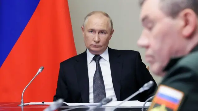 An up close shot of Putin at the meeting with officials