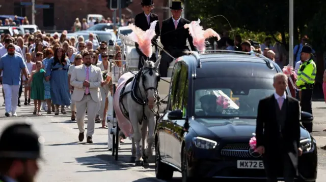 The coffin of Alice da Silva Aguiar, one of the three children who were victims of a knife attack during a dance event, arrives at St Patrick's Catholic Church, in Southport on Sunday