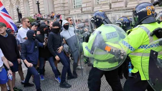 Police officers and demonstrators clash during a protest against illegal immigration in Liverpool