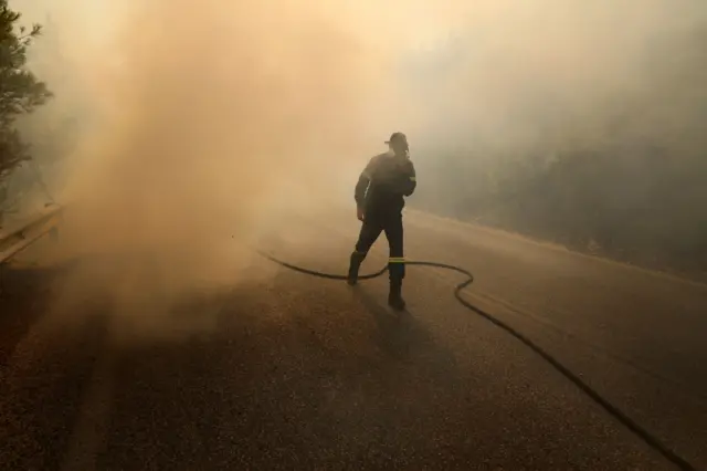 A firefighter surrounded by smoke