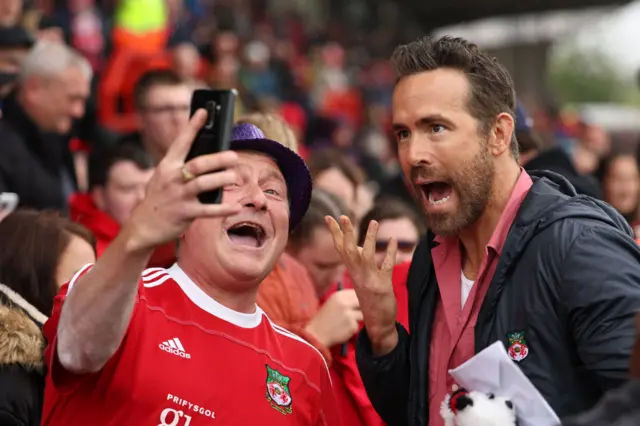 Ryan Reynolds poses for a picture with a Wrexham fan