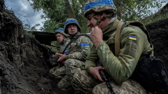 Ukrainian servicemen hide from shelling, amid Russia's attack on Ukraine, near the Russian border in Sumy region,