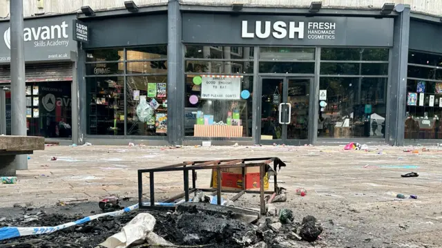 A street littered with debris in front of the Lush store in Hull