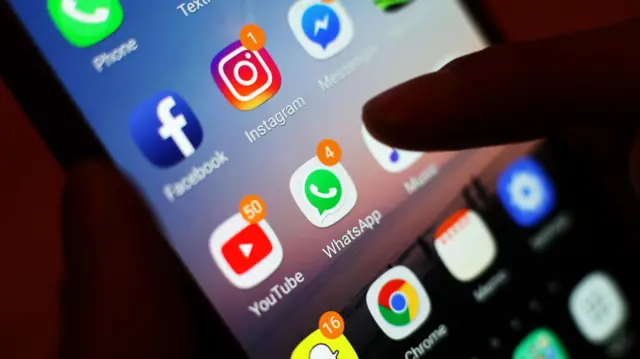 Social media apps, including Facebook, Instagram, YouTube and WhatsApp, displayed on a mobile phone screen