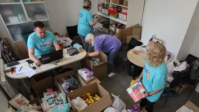 Volunteers sort a humanitarian aid for residents of Kursk region at the humanitarian collection point 'Moscow Helps' in Moscow, Russia, 14 August 2024.