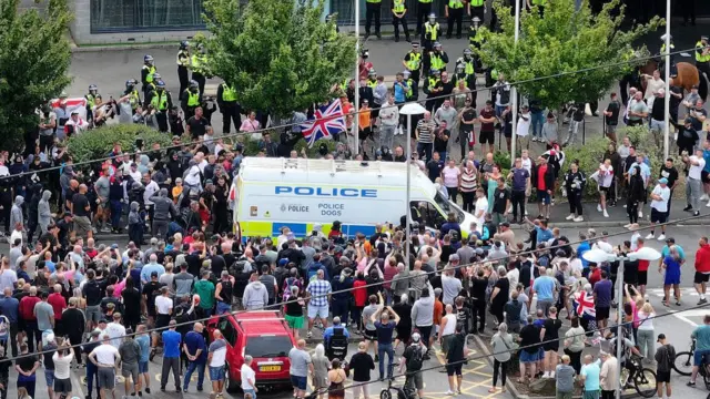 An aerial view of anti-migration protesters stand outside of the Holiday Inn Express in Manvers, near Rotherham