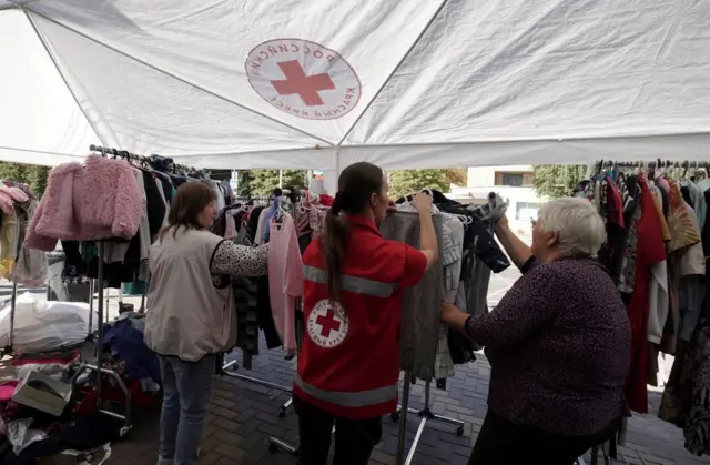 Displaced people receive humanitarian aid at a Russian Red Cross distribution point in Kursk