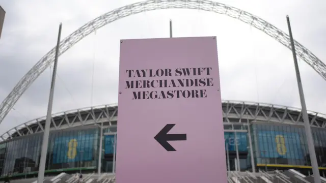 Sign towards merchandise stall