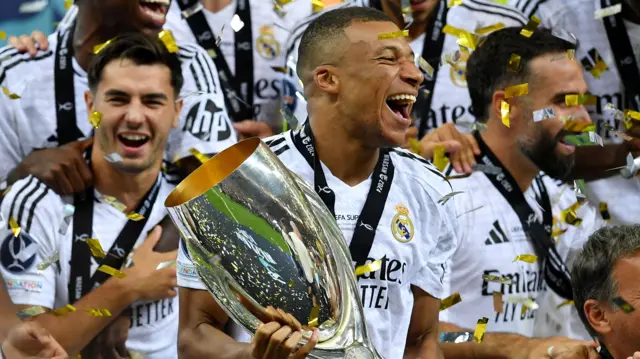 Kylian Mbappe with the Uefa Super Cup trophy