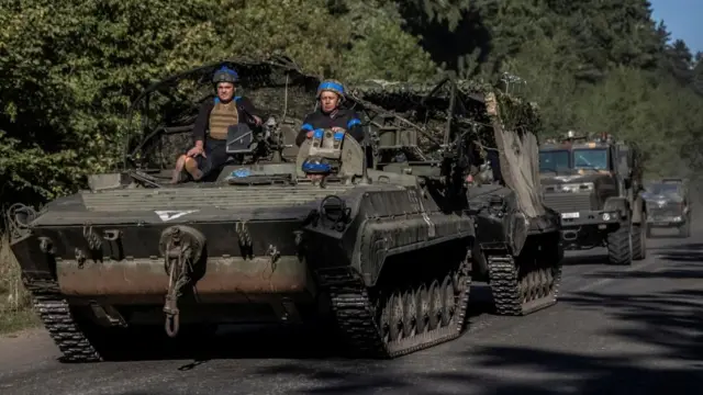 Ukrainian servicemen ride an armoured personnel carrier, amid Russia's attack on Ukraine, near the Russian border in Sumy region