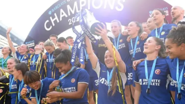 Chelsea players celebrate with the Women's Super League trophy in 2024