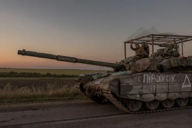 Ukrainian servicemen operate a tank on a road near the border with Russia, in the Sumy region of Ukraine, 14 August