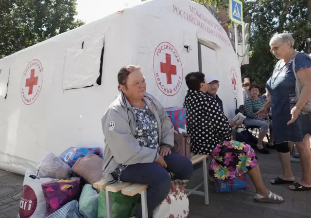 Displaced people receive humanitarian aid at a Russian Red Cross distribution point in Kursk