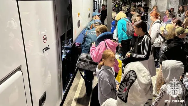 Russian citizens arrive at a railway station to travel to temporary accommodation centres in Nevinnomyssk, Mineralnye Vody and Shpakovsky municipalities