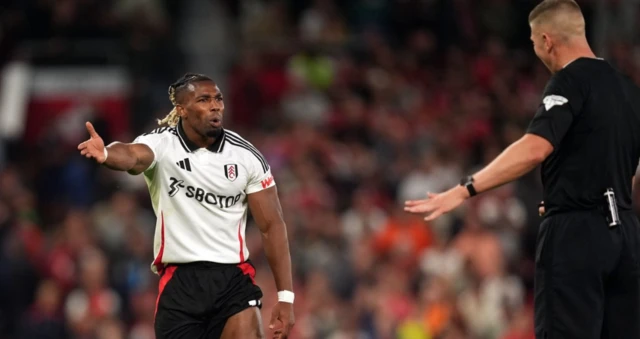 Adama Traore speaks to the referee