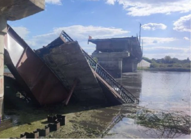 A bridge with parts collapsed into water below